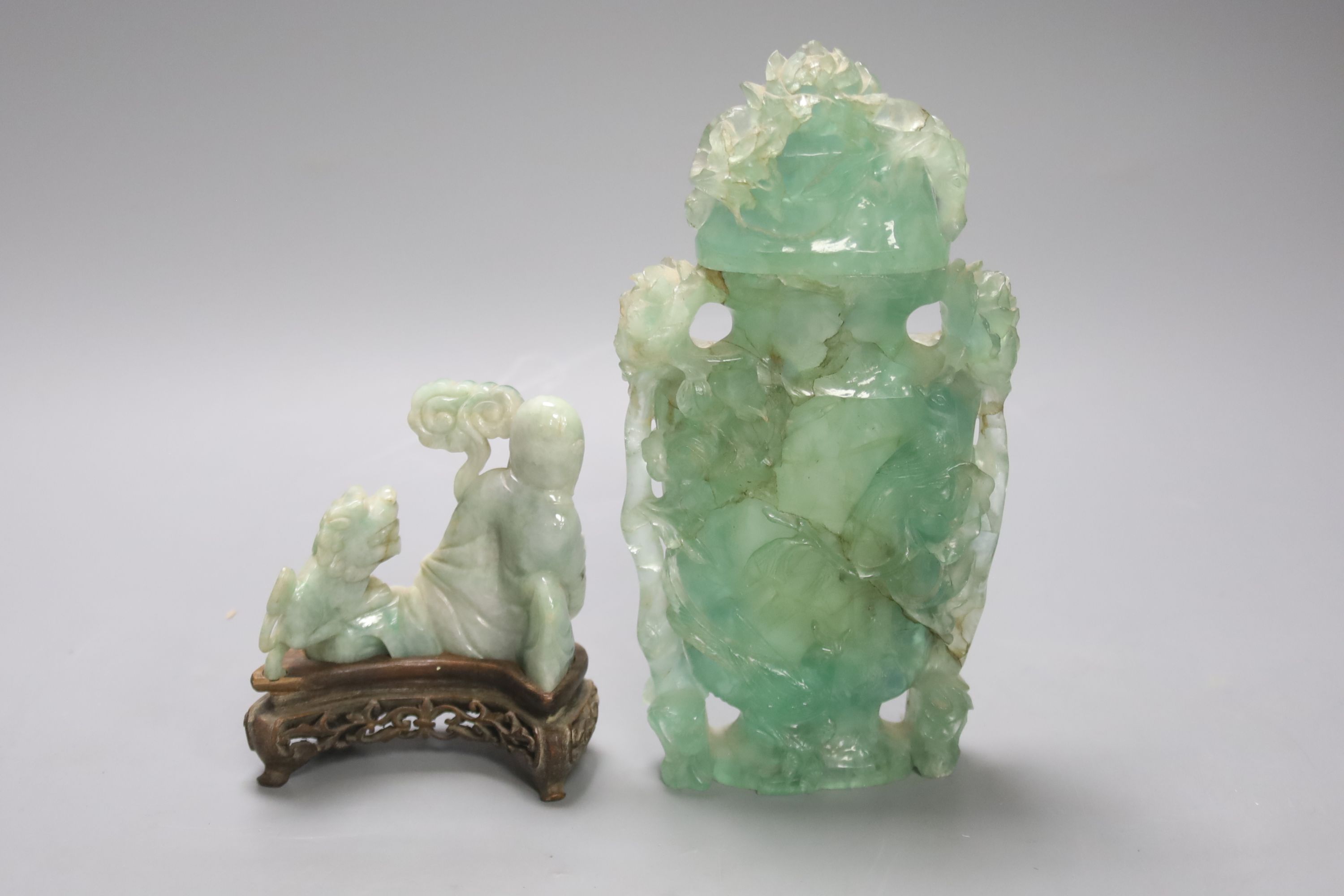 A Chinese jadeite carving of a Luohan and a green quartz vase and cover, 20cm (2)